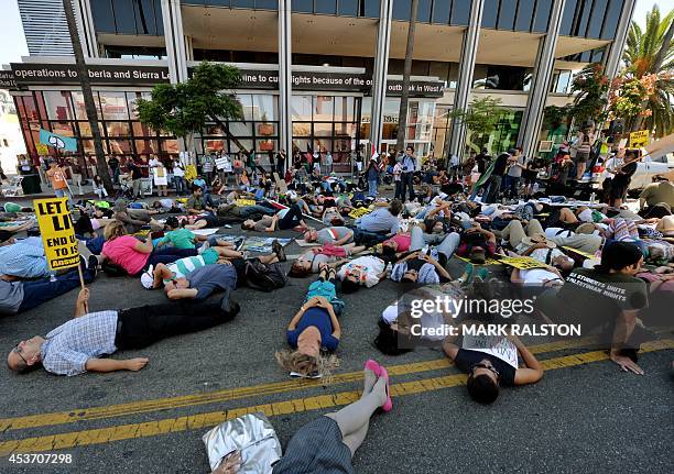 Palestinian Americans and their supporters hold a "die in" outside the CNN headquarters during their protest march against the ongoing conflict in...