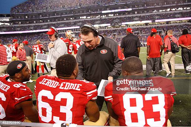 Defensive Line Coach Jim Tomsula of the San Francisco 49ers talks with Tony Jerod-Eddie and Demarcus Dobbs during the game against the Baltimore...