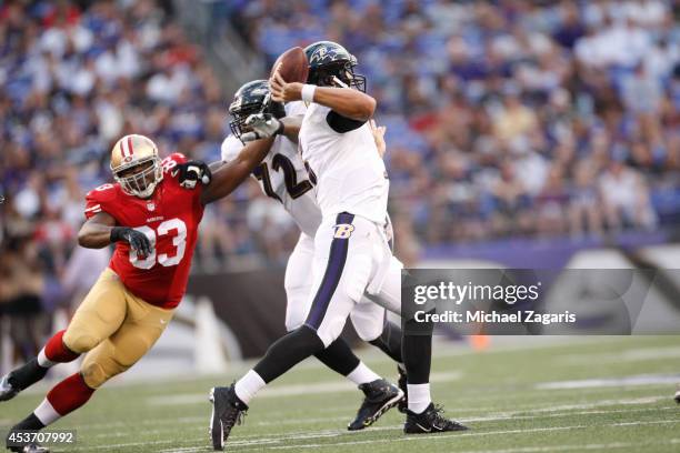 Demarcus Dobbs of the San Francisco 49ers pressures Joe Flacco of the Baltimore Ravens during the game at M&T Bank Stadium on August 7, 2014 in...