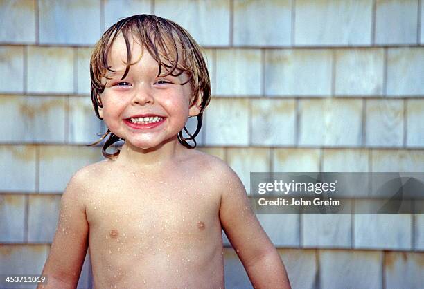 Boy enjoying an outdoor shower.