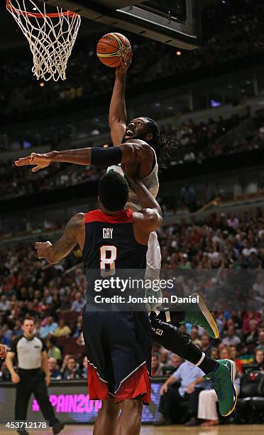 Nene Hilario of team Brazil goes up for a shot over Rudy Gay of team USA during an exhibition game at the United Center on August 16, 2014 in...