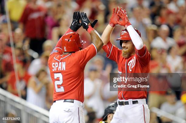 Adam LaRoche of the Washington Nationals celebrates with Denard Span after hitting a two-run home run in the eighth inning against the Pittsburgh...