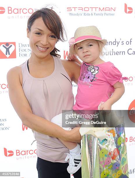 Actress Mayte Garcia and daughter Gia arrive at The Dave Thomas Foundation for adoption's kickball for a home celebrity kickball game at University...