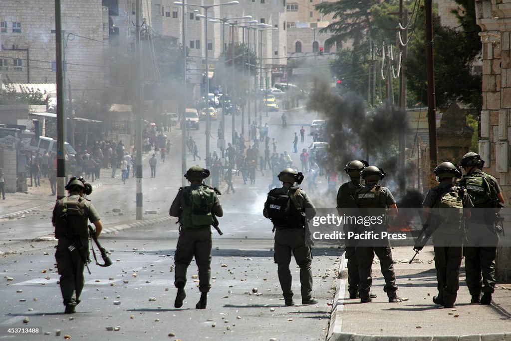 The Israeli soldiers keep on guard against the Palestinian...