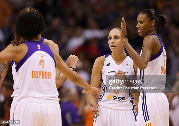 Diana Taurasi of the Phoenix Mercury high-fives Candice Dupree and DeWanna Bonner after scoring against the Los Angeles Sparks during the first half...