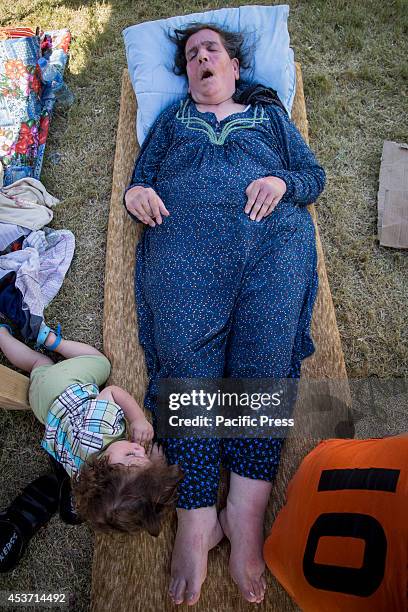 Disabled Kurdish woman lies in the shade outside Saint Joseph Church. 650 Christian families have taken shelter inside Saint Joseph Church, after an...