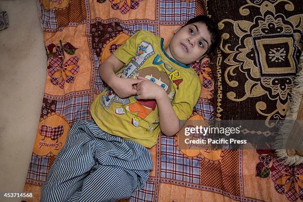 Disabled Kurdish child lays down at Saint-Joseph church. 650 Christian families have taken shelter inside Saint Joseph Church, after an unprecedented...