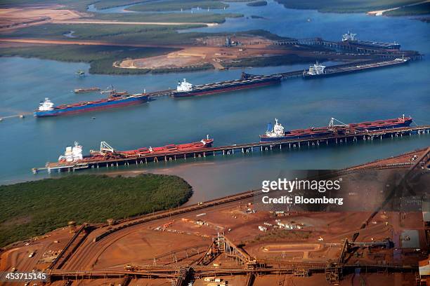 Bulk carriers are loaded with iron ore at the ship loading facility at Fortescue Metals Group Ltd.'s Herb Elliott Port in Port Hedland in the Pilbara...