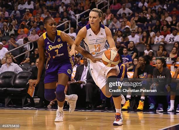 Penny Taylor of the Phoenix Mercury drives the ball past Sandrine Gruda of the Los Angeles Sparks during the second half of the WNBA game at US...
