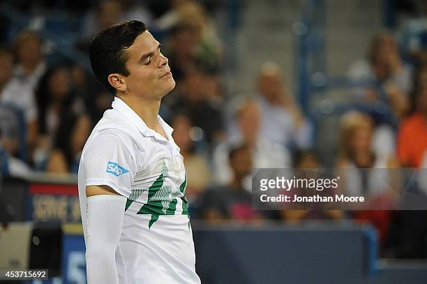 Milos Raonic of Canada reacts during a match against Roger Federer of Switzerland on day 8 of the Western & Southern Open at the Linder Family Tennis...