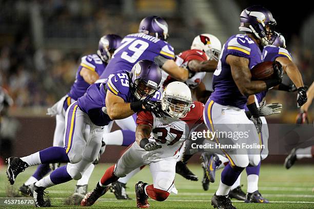 Zac Kerin of the Minnesota Vikings tackles Anthony Walters of the Arizona Cardinals as Joe Banyard of the Minnesota Vikings returns a punt during the...