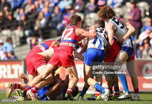 Players wrestle during the round 21 AFL match between the North Melbourne Kangaroos and the Western Bulldogs at Etihad Stadium on August 17, 2014 in...