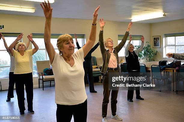 Elderly people take part in an exercise class at the AgeUK Ann Owens Centre on December 4, 2013 in Barnet, England. AgeUK are a nationwide charity...
