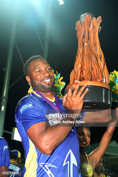 Barbados Tridents captain Kieron Pollard poses with the winners trophy during the Limacol Caribbean Premier League 2014 final match between Guyana...