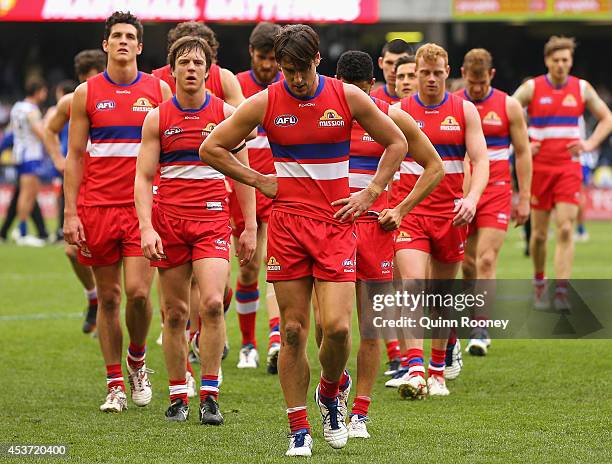 Ryan Griffen and his Bulldogs look dejected as they leave the field after losing the round 21 AFL match between the North Melbourne Kangaroos and the...