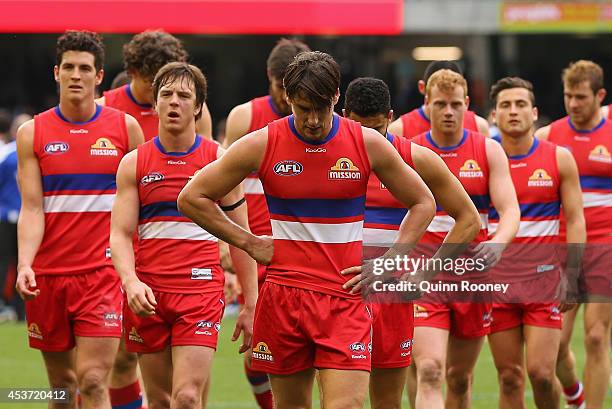 Ryan Griffen and his Bulldogs look dejected as they leave the field after losing the round 21 AFL match between the North Melbourne Kangaroos and the...