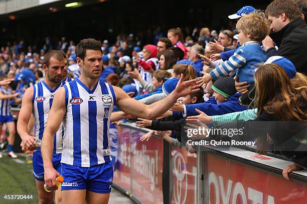 Sam Gibson of the Kangaroos high fives fans after winning the round 21 AFL match between the North Melbourne Kangaroos and the Western Bulldogs at...