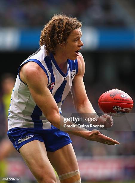 Ben Brown of the Kangaroos handballs during the round 21 AFL match between the North Melbourne Kangaroos and the Western Bulldogs at Etihad Stadium...