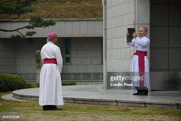 Bishops take photos before the arrival of Pope Francis for a meeting with Asian bishops at the Haemi Martyrs Shrine on August 17, 2014 in Haemi,...