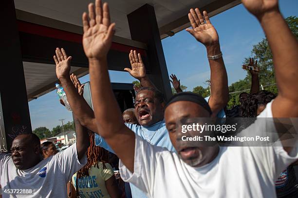 People react following the disclosure by Ferguson Police Chief Thomas Jackson of the name of the Ferguson police officer responsible for the August...