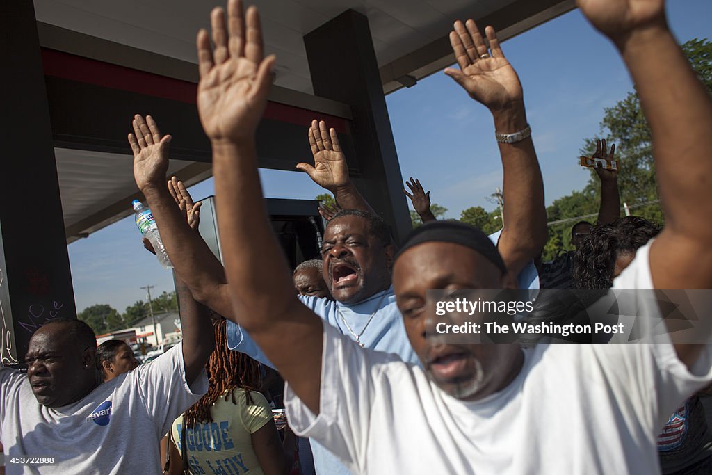 FERGUSON, MO - AUGUST 15: People react following the disclosure