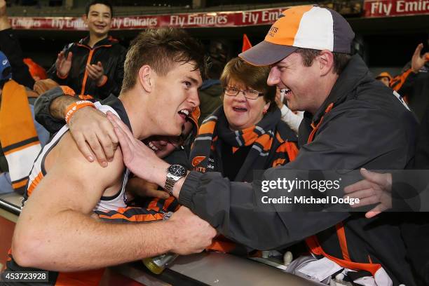 Adam Tomlinson of the Giants celebrates the win with fans during the round 21 AFL match between the Melbourne Demons and the Greater Western Sydney...