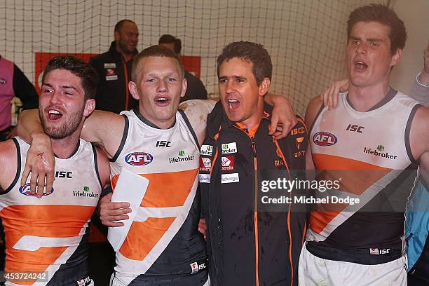 Devon Smith Adam Treloar, coach Leon Cameron and Tom Boyd of the Giants celebrate their win during the round 21 AFL match between the Melbourne...