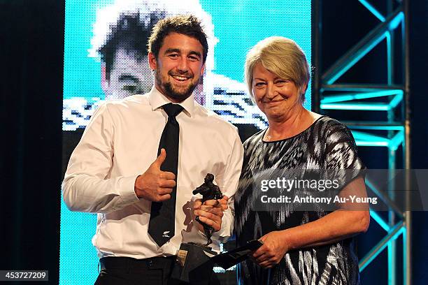 Kurt Baker receives the Richard Crawshaw Memorial All Blacks Sevens Player of the Year award from Sam Crawshaw during the 2013 Steinlager Rugby...