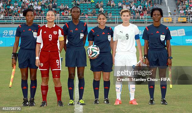 Match Officials and Deyna Castellanos of Venezuela and Maria Mikolajova of Slovakia pose during the FIFA Girls Summer Olympic Football Tournament...