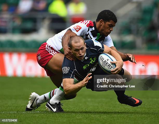 Michael Nelson of Seattle is tackled by Simon Pitfield of Harlequins during the Shield Final match between Harlequins and seattle during the World...