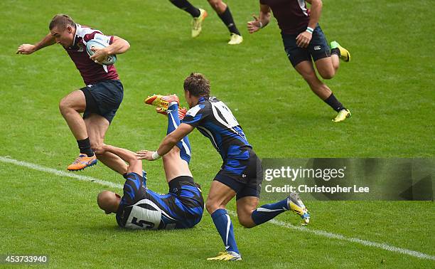 Vladimir Ostroushko of Ruban jumps a tackle from Andrei Temnov of Enisei during the Cup Quarter Final match between Ruban Krasnodar and RC Enisei...