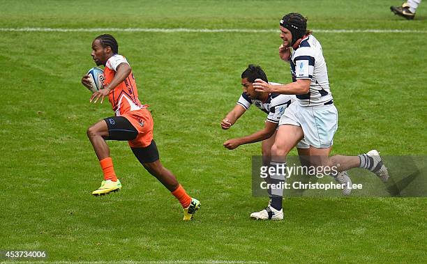 Carlin Isles of New York gets away from Rocky Khan and Jeremy Innes of Auckland to score a try during the Cup Quarter Final match between Auckland...