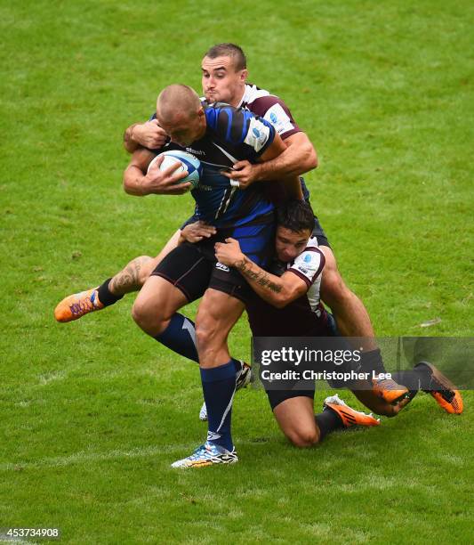 Denis Simplikevich of Enisei is tackled by Roman Roshchin and Vladimir Ostroushko of Ruban during the Cup Quarter Final match between Ruban Krasnodar...