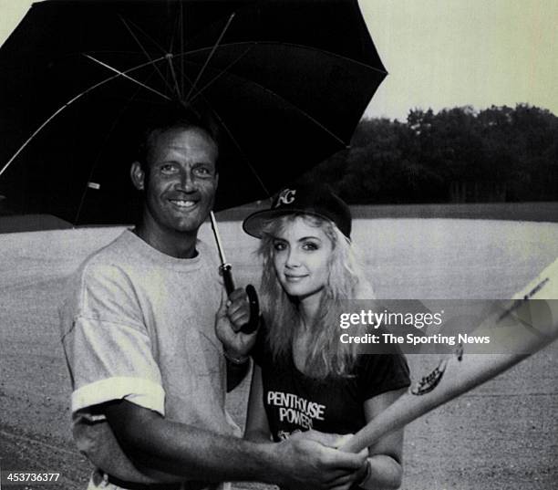 George Brett of the Royals and penthouse pet Patty Mullen take shelter under an umbrella during the rain in New York's Central Park circa 1989.