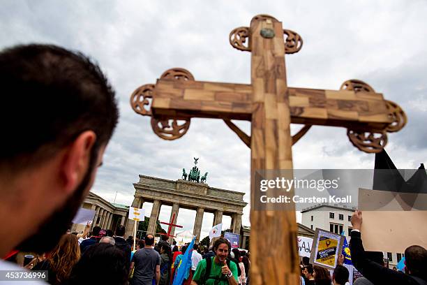 Protester holds a crucifix as more then thousand participants of several oriental christian groups gather to protest against the ongoing violence...