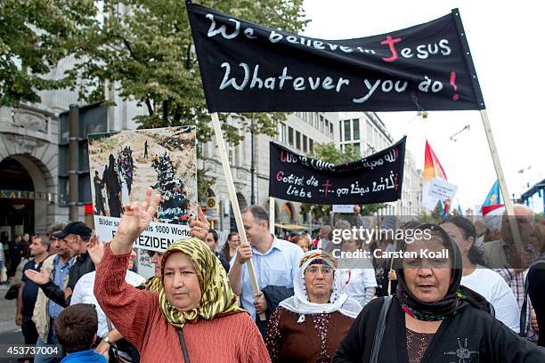 Protester holds a banner as more then thousand participants of several oriental christian groups gather to protest against the ongoing violence...