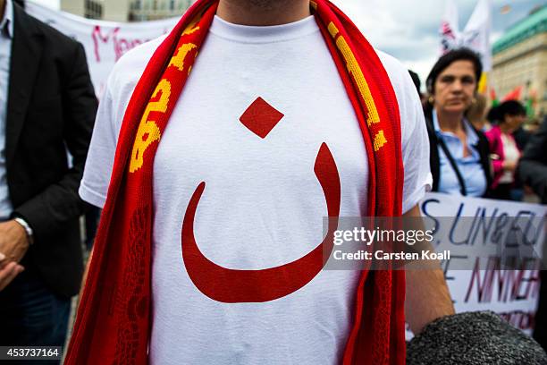 Protester shows the arabic letter for christian on his shirt as more then thousand participants of several oriental christian groups gather to...