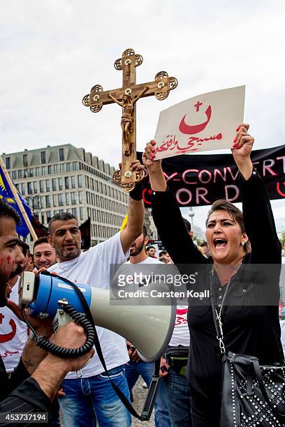 Protester holds a crucifix as more then thousand participants of several oriental christian groups gather to protest against the ongoing violence...