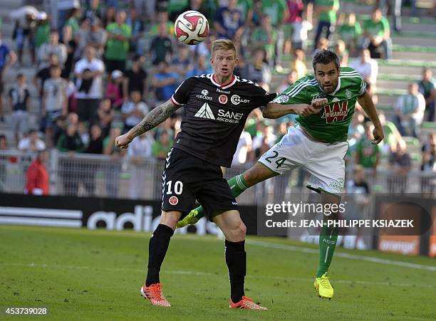 Reims' French forward Gaetan Charbonnier vies with St Etienne's French defender Loic Perrin during the French L1 football match AS Saint-Etienne vs...