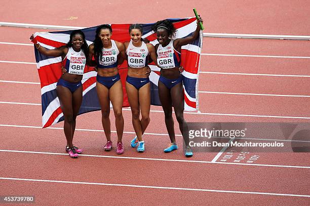 Asha Philip, Ashleigh Nelson, Jodie Williams and Desiree Henry of Great Britain and Northern Ireland pose with a Union Jack after winning gold in the...