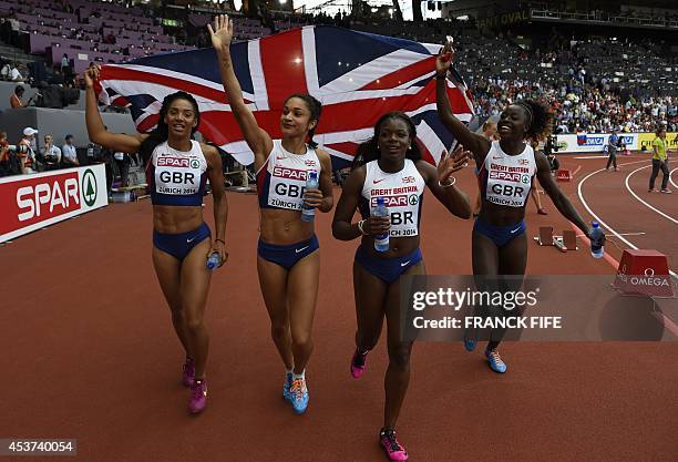 Great Britain's Ashleigh Nelson, Great Britain's Jodie Williams, Great Britain's Asha Philip and Great Britain's Desiree Henry, holding their...