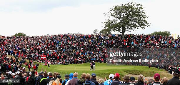 Thomas Bjorn of Denmark takes a selfie with his caddie Dominic Bott and Oliver Fisher of England on the 16th green during the final round of the Made...