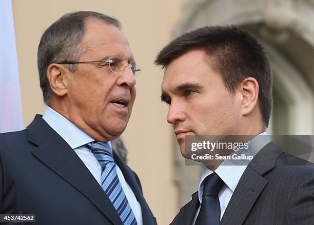 Russian Foreign Minister Sergey Lavrov and Ukrainian Foreign Minister Pavlo Klimkin pass by one another while arriving for a group photo with French...