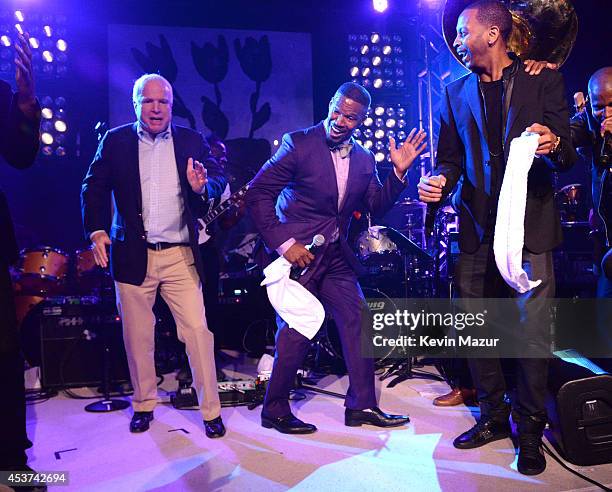 Arizona Senator John McCain and Jamie Foxx dance onstage at Apollo in the Hamptons at The Creeks on August 16, 2014 in East Hampton, New York.