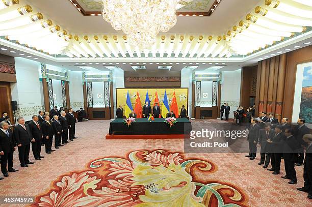 Ukrainian President Viktor Yanukovych and Chinese President Xi Jinping attend a signing ceremony at the Great Hall of the People in Beijing on...