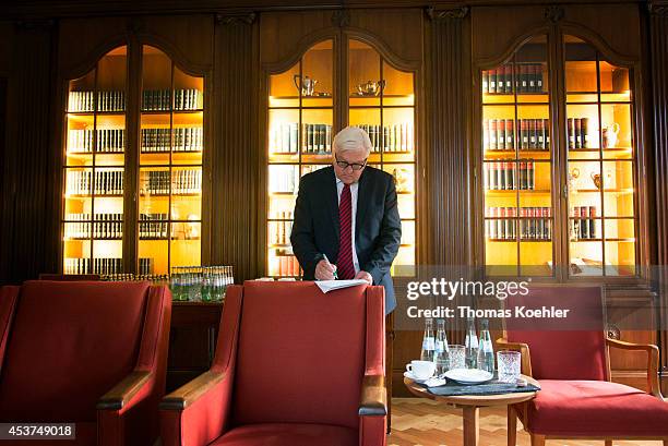 German Foreign Minister Frank-Walter Steinmeier prepares himself to discuss the ongoing conflict in eastern Ukraine at Villa Borsig with the foreign...