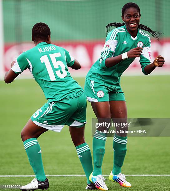 Asisat Oshoala of Nigeria celebrates her team's first goal with team mate Ugo Njokuduring the FIFA U-20 Women's World Cup Canada 2014 Quarter Final...