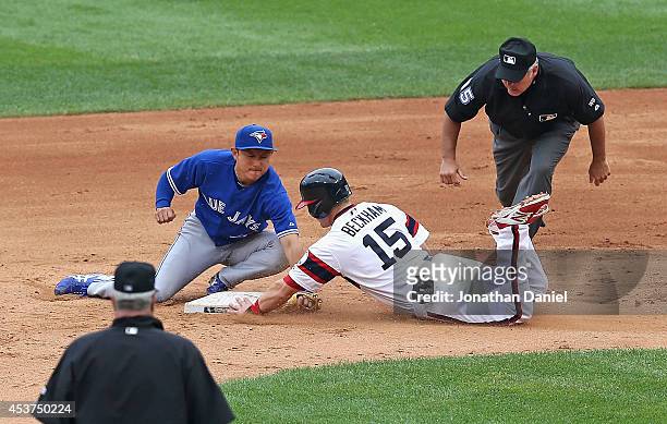 Munenori Kawasaki of the Toronto Blue Jays tags out Gordon Beckham of the Chicago White Sox as second base umpire Tim Welke watches the play in the...