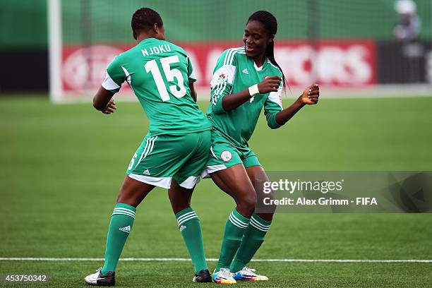 Asisat Oshoala of Nigeria celebrates her team's first goal with team mate Ugo Njokuduring the FIFA U-20 Women's World Cup Canada 2014 Quarter Final...