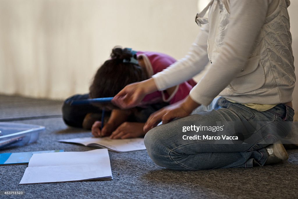 Children doing homework on the floor